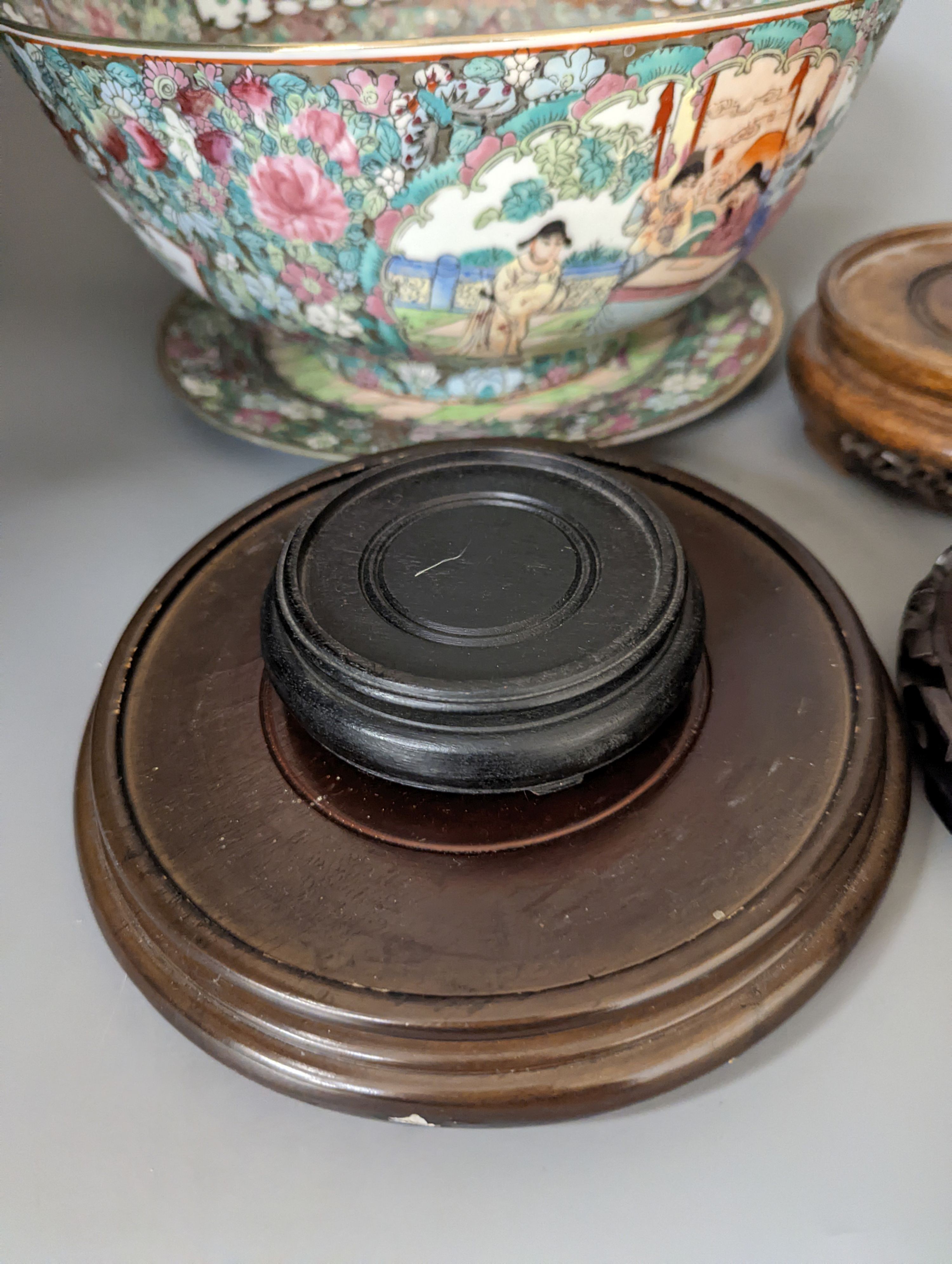 A Chinese famille rose bowl, plate and four stands, bowl 31 cms diameter.